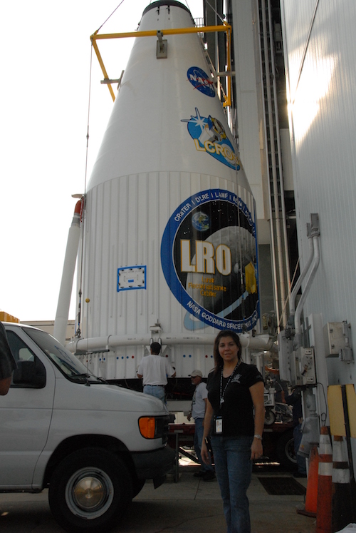 Diana Calero stands with the rocket carrying the Lunar Reconnaisance Orbiter spacecraft.