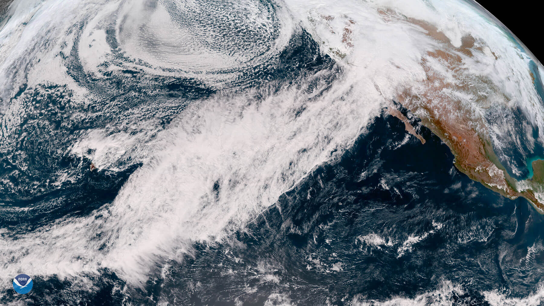 Image of a conveyor belt of clouds and moisture stretching across the Pacific.