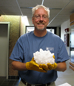 Man holding huge hailstone.