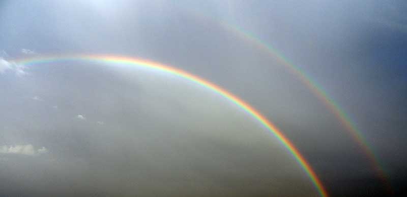 full rainbows in the sky