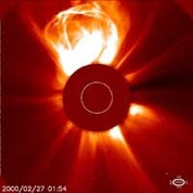 Image of Sun's corona, with Sun's disk blocked out. A looping bright solar storm as large as the Sun's diameter is visible in the corona at top of image.