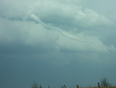 Photo of a horizontal funnel cloud.