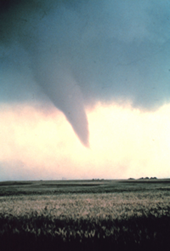 Photo of funnel cloud nearly touching ground.