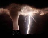 Photo of tornado with huge lightning bolt from cloud to ground.