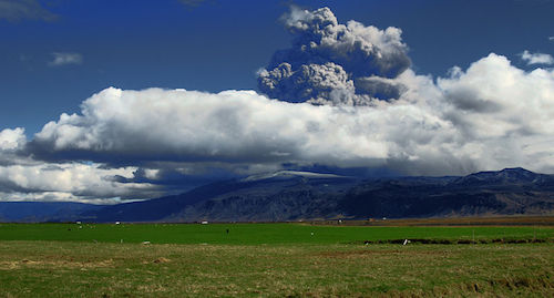 Photo of thick, light gray, billowing clouds of volcanic ash.