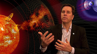 The Space Weather Prediction Center's Tom Berger sits against a backdrop of space showing the sun