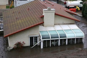 A home damaged by a mudflow is pictured in the area of the 2013 Springs Fire, in Camarillo, California, Dec. 2, 2014. The area was under mandatory evacuation as a powerful winter storm brought heavy rain to southern California burn areas in Ventura, Los Angeles, Orange and San Diego counties. CREDIT: Jonathan Alcorn/Reuters
