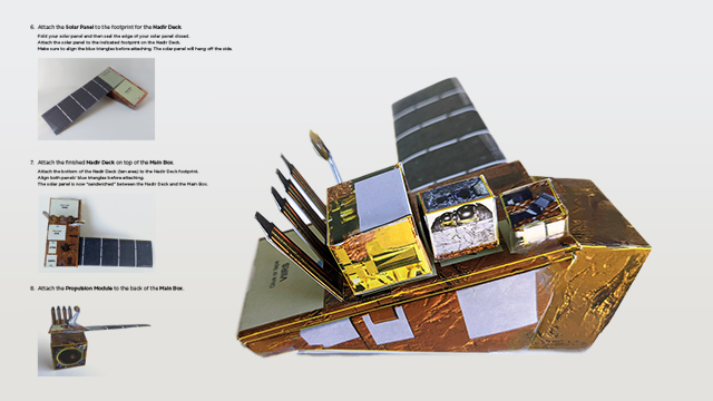 Photo of a paper construction of a satellite.