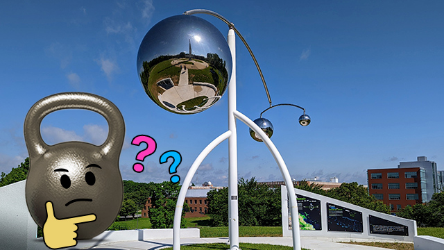 Composite illustration of a kettlebell with a thinking emoji in front of a steel sculpture outdoors