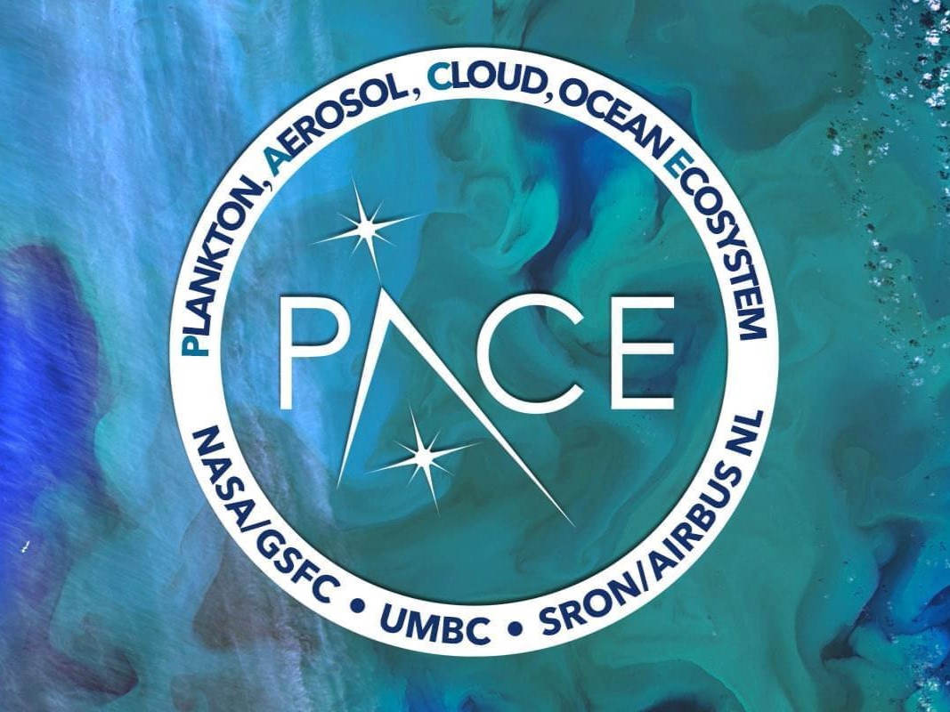 The image shows the PACE mission emblem with a circular design. The center features the word "PACE" with two stars, and the outer ring contains the words "Plankton, Aerosol, Cloud, Ocean Ecosystem" and "NASA/GSFC - UMBC - SRON/AIRBUS NL" on a blue and teal oceanic background.
