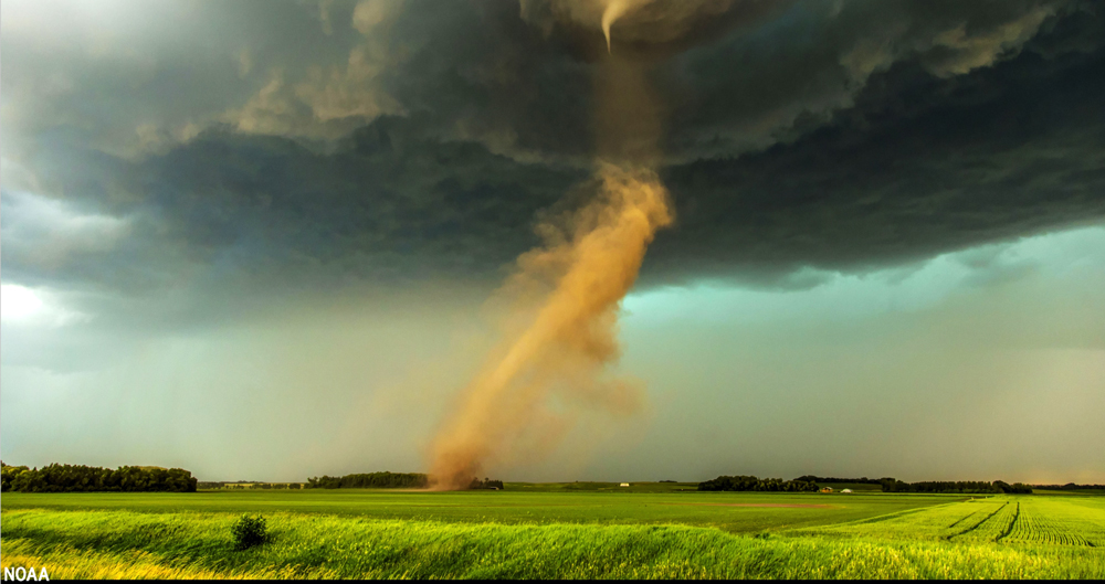 Tornado swirling over an open field