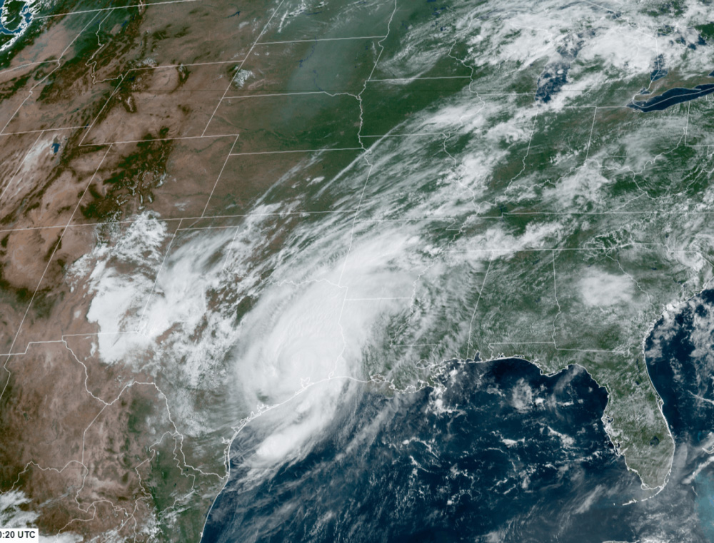  satellite image showing a large, spiraling storm system over the southern United States, particularly impacting Texas and Louisiana, with cloud cover extending across multiple states.