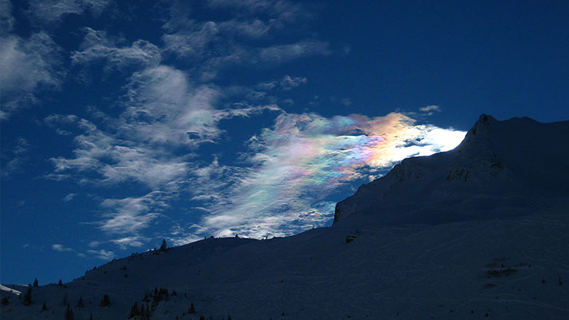 Rainbow clouds seen over a mountain