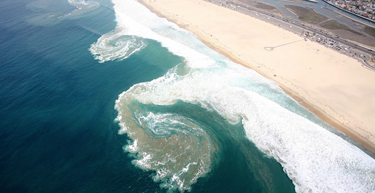 Image of waves hitting a beach.