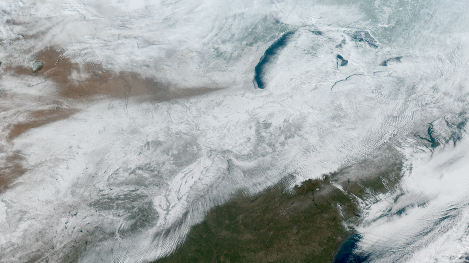 Winter storm seen from space over the US. It is grey and white clouds.