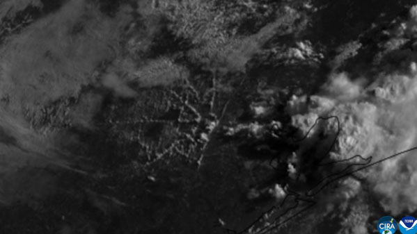 Visible (band 2) imagery from NOAA's GOES East (GOES-19) satellite from June 2, 2026 shows long, narrow bands of clouds stretching across the sky that lined up with many of the major roads and highways in Houston, Texas. .
